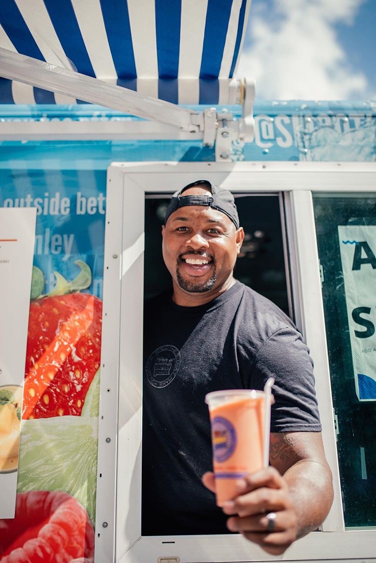 Keon Davis serving smoothies